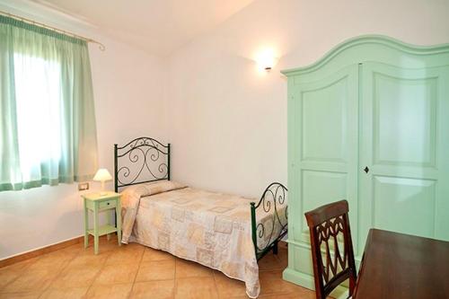 Ένα ή περισσότερα κρεβάτια σε δωμάτιο στο Residence with swimming pool just 5 minutes from Budoni, apartments with air conditoning and private outdoor area