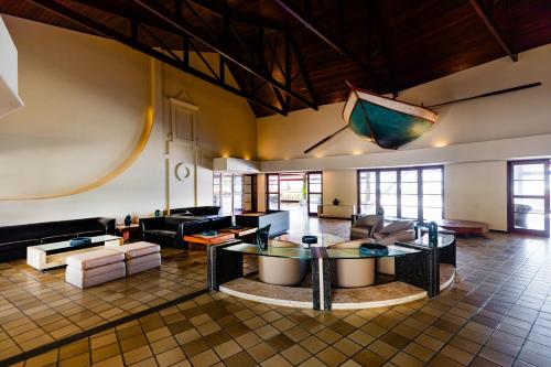 a large living room with a kite hanging from the ceiling at Mirai Beach Hotel in Natal