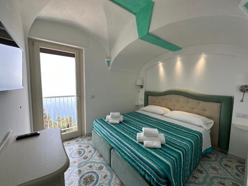 a bedroom with a bed with two towels on it at Agriturismo Miramare in Agerola