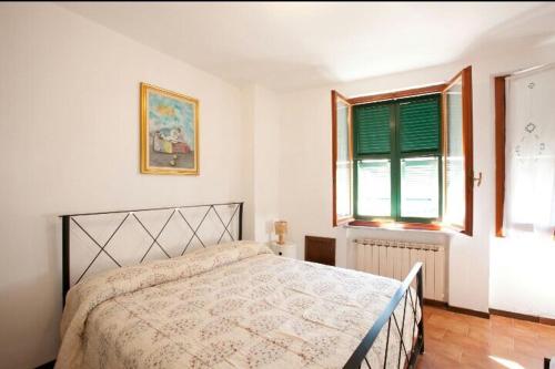 a bedroom with a bed and a window at Good Vibes Apartment in Monterosso al Mare