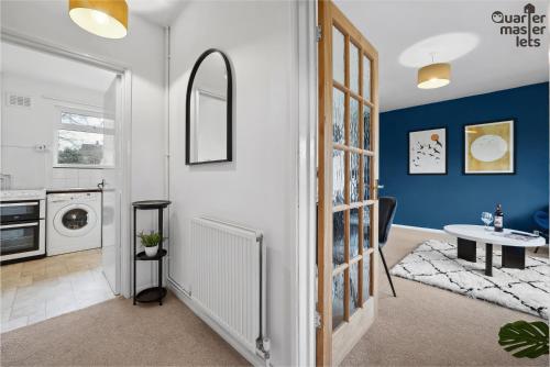 a laundry room with a washer and dryer at 2 Bedroom Bungalow with Parking that Sleeps 6 in West Horsley