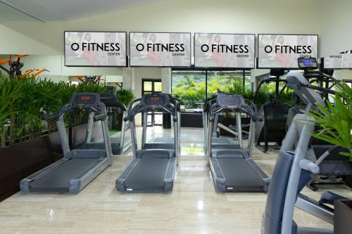 a gym with several treadmills in a building at Oh! Cancun - The Urban Oasis & Beach Club in Cancún