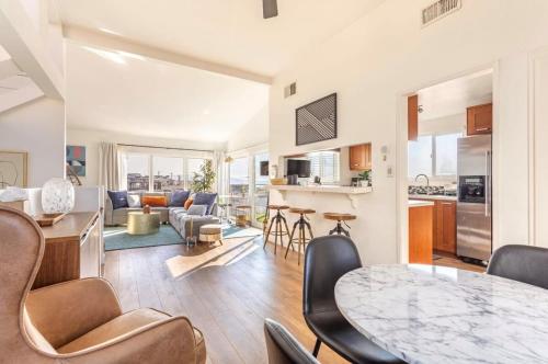 a kitchen and living room with a table and chairs at Exclusive Ocean & Pier View Family Escape in Manhattan Beach