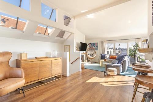 a living room with a refrigerator and a table at Exclusive Ocean & Pier View Family Escape in Manhattan Beach