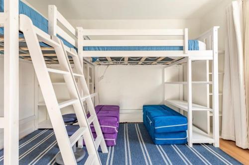 a bunk bed room with purple and blue bunk beds at Exclusive Ocean & Pier View Family Escape in Manhattan Beach