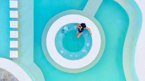 an overhead view of a person in a wave pool at The Sens Tulum Riviera by Oasis in Akumal