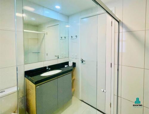a bathroom with a sink and a mirror at Aquarius Style by Holiday Stays in Fortaleza