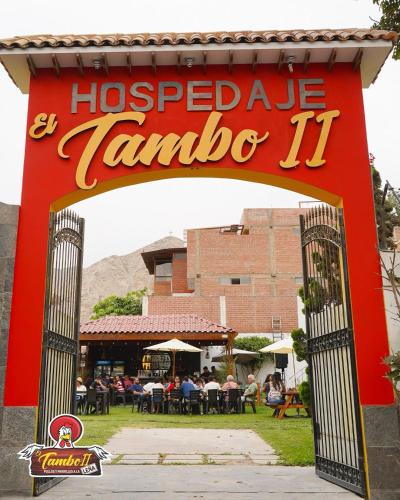 a sign for a restaurant with people sitting at tables at Tambo II Hotel Campestre in Cieneguilla