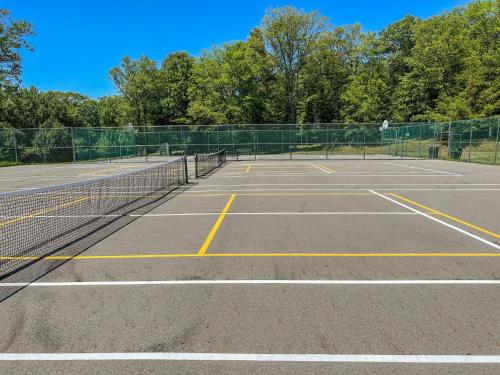 a tennis court with two tennis courts at Chalet in Masthope Community in Lackawaxen