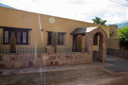 a house with a water fountain in front of it at Casa en el corazón de Huacalera, Jujuy in Tilcara