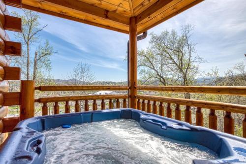 a hot tub on the deck of a cabin at Blue Bear Splash in Pigeon Forge
