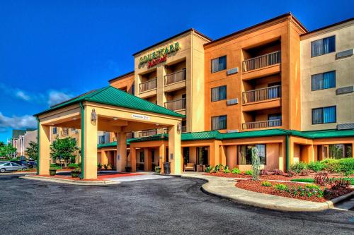 a hotel with a parking lot in front of it at Courtyard by Marriott Burlington in Burlington
