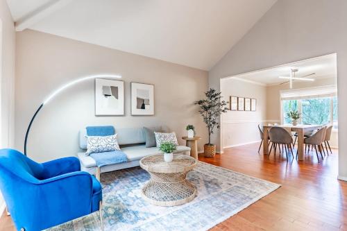 a living room with a blue couch and a table at Spacious & Serene 6-Br Family Retreat in Kirkland in Kirkland