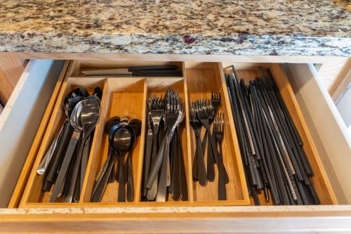 a drawer filled with utensils in a kitchen at Spacious & Serene 6-Br Family Retreat in Kirkland in Kirkland