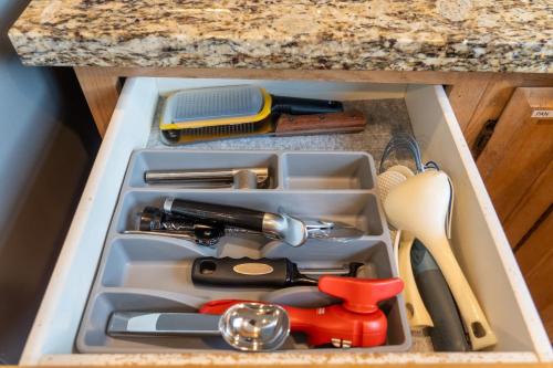 a drawer filled withrenches and other kitchen utensils at Spacious & Serene 6-Br Family Retreat in Kirkland in Kirkland