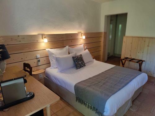 a bedroom with a bed and a desk with a laptop at Le Mas des Laurels in Chantemerle-lès-Grignan