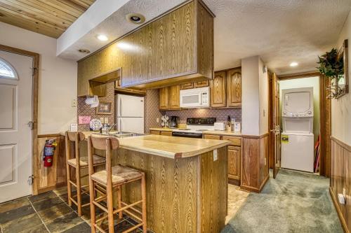 a kitchen with wooden cabinets and a counter with stools at BlackBerry Ridge in Pigeon Forge
