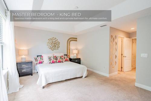 a bedroom with a white bed with pillows at 3BD Townhouse , Themed , 10 min to Disney , Gated in Kissimmee