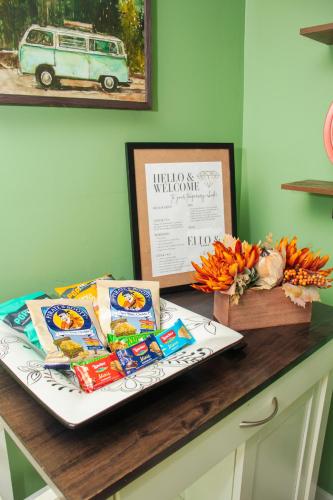 a table with food and a picture of a van at Exceptional & Central, Garden Suite, Top Amenities & Care! in Central Islip