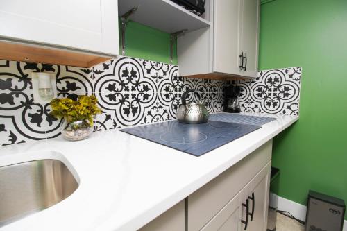 a kitchen with green walls and a white counter top at Exceptional & Central, Garden Suite, Top Amenities & Care! in Central Islip