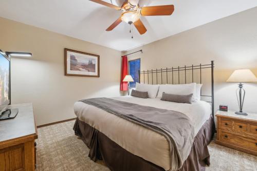 a bedroom with a large bed and a ceiling fan at Eagle Point Resort in Vail