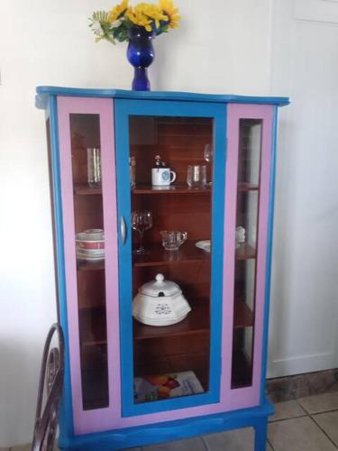 a blue and pink cabinet with a vase on top at Beachfront Suite 5 Coqui in Vieques