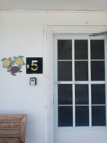 a door with a number sign next to it at Beachfront Suite 5 Coqui in Vieques
