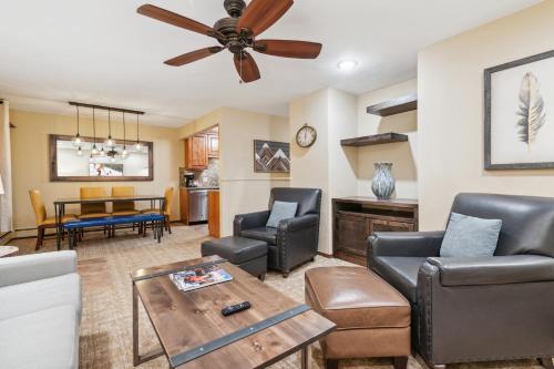 a living room with furniture and a ceiling fan at Eagle Point Resort in Vail