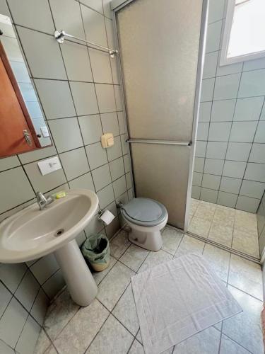 a bathroom with a sink and a toilet at Tulipa Hotel in Foz do Iguaçu