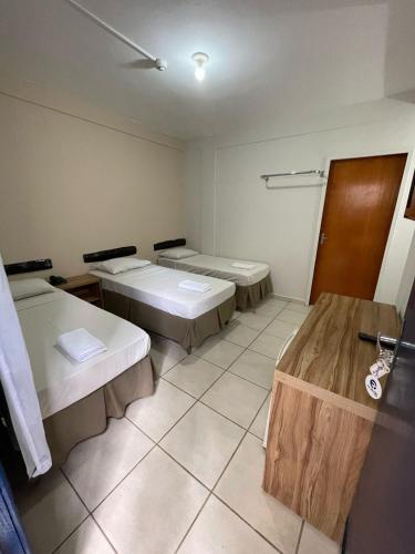 a room with three beds in a room at CR Hotel Bueno in Goiânia