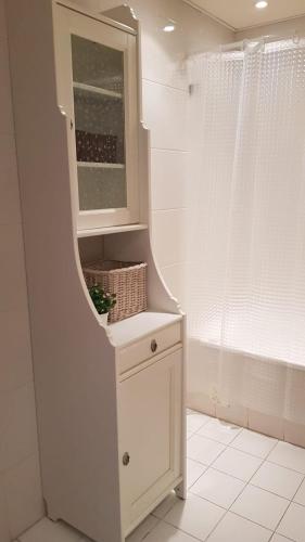 a bathroom with a white cabinet and a mirror at Casa Tété in Faro