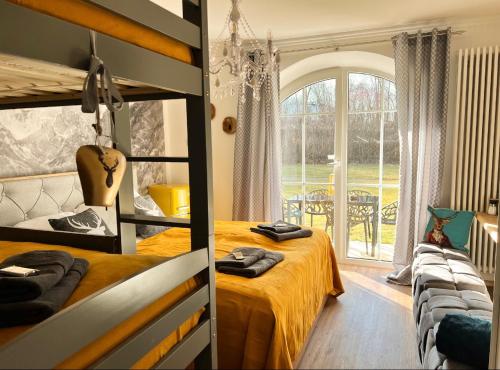 two images of a bedroom with a bed and a window at Bavaria Mountain Lodge Chalet DESIGN Ferienwohnung SKI Arber Osser Terrasse Sauna in Villa bis 5 Pers in Hohenwarth