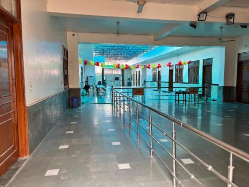 a hallway of a building with tables and balloons at Shri Gaya Prasad Dham in Vrindāvan