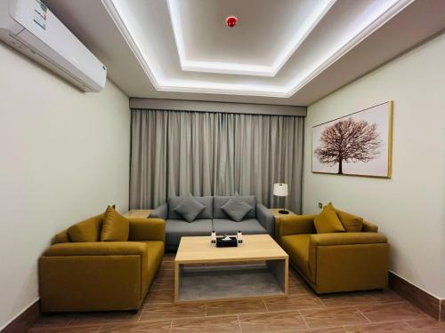 a living room with two couches and a coffee table at فندق سفن دريم in Al Kharj