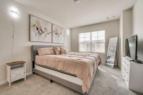 a bedroom with a large bed and a tv at Davenport Home w/ Pool Access & Patio! in Davenport