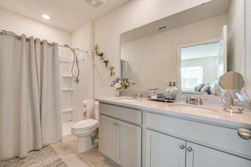 a bathroom with a sink and a toilet and a mirror at Davenport Home w/ Pool Access & Patio! in Davenport