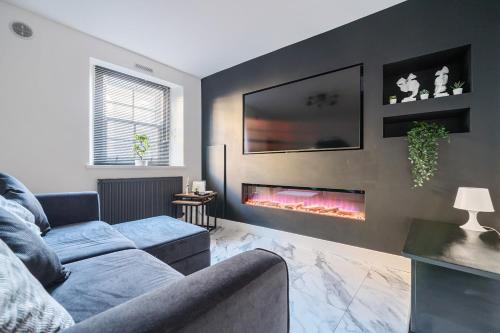 a living room with a couch and a fire place at Modern Town House In Cockermouth in Cockermouth