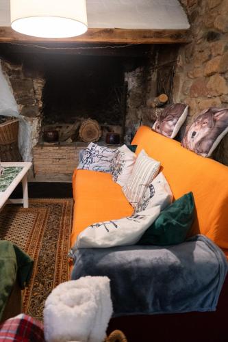 two beds in a room with a fireplace at Masia Cal Fuster in Joanet