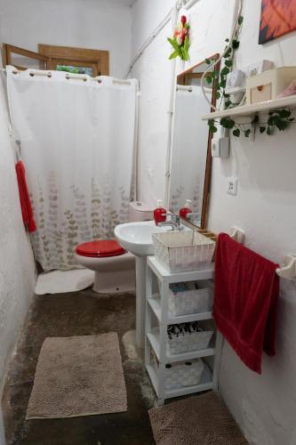 a bathroom with a white sink and a toilet at Masia Cal Fuster in Joanet