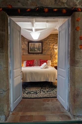 a bedroom with a bed with red pillows at Masia Cal Fuster in Joanet