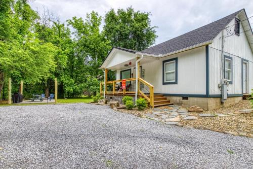 a house with a porch and a driveway at River Cottage in Pigeon Forge