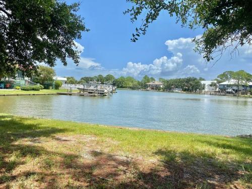 a view of a river with a dock in the distance at Weekend Away in Dauphin Island