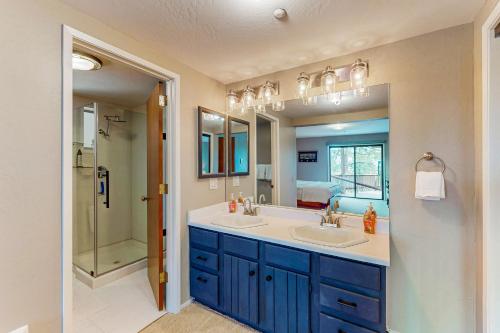 a bathroom with two sinks and a large mirror at Cliffside Retreat in Zephyr Cove