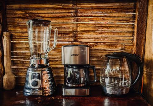 a blender and a coffee maker on a table at Toucan Lodge in Puyo