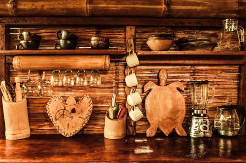 a wooden shelf with utensils and items on it at Toucan Lodge in Puyo