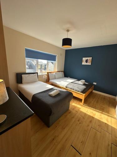 a hotel room with two beds and a window at Waterlane Apartments in Galway