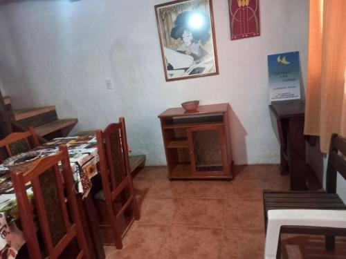 a room with two beds and a table and chairs at Casa Cinco in La Pedrera