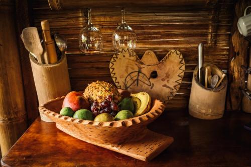a basket of fruit sitting on a table at Toucan Lodge in Puyo