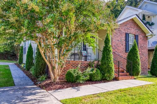a brick house with a tree in a yard at Sparkling Waters in Pigeon Forge