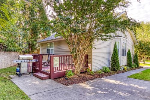 a house with a deck and a grill in a yard at Sparkling Waters in Pigeon Forge